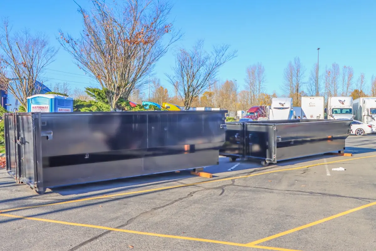 Professional dumpster rental service with roll-off container on residential driveway in Posen